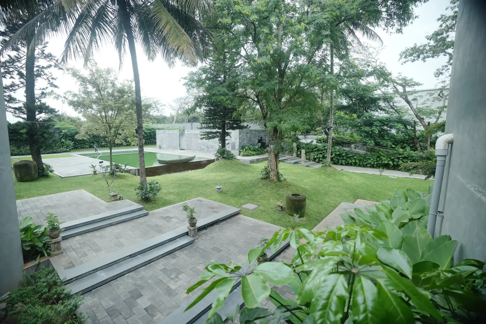 Pool, lawn and tropical canopy